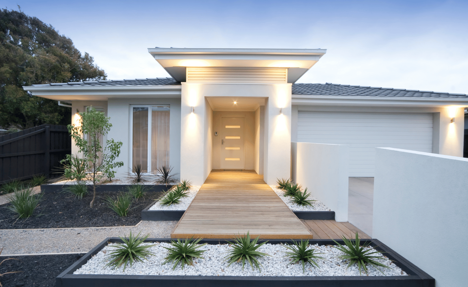 white home with exotic plants and landscape